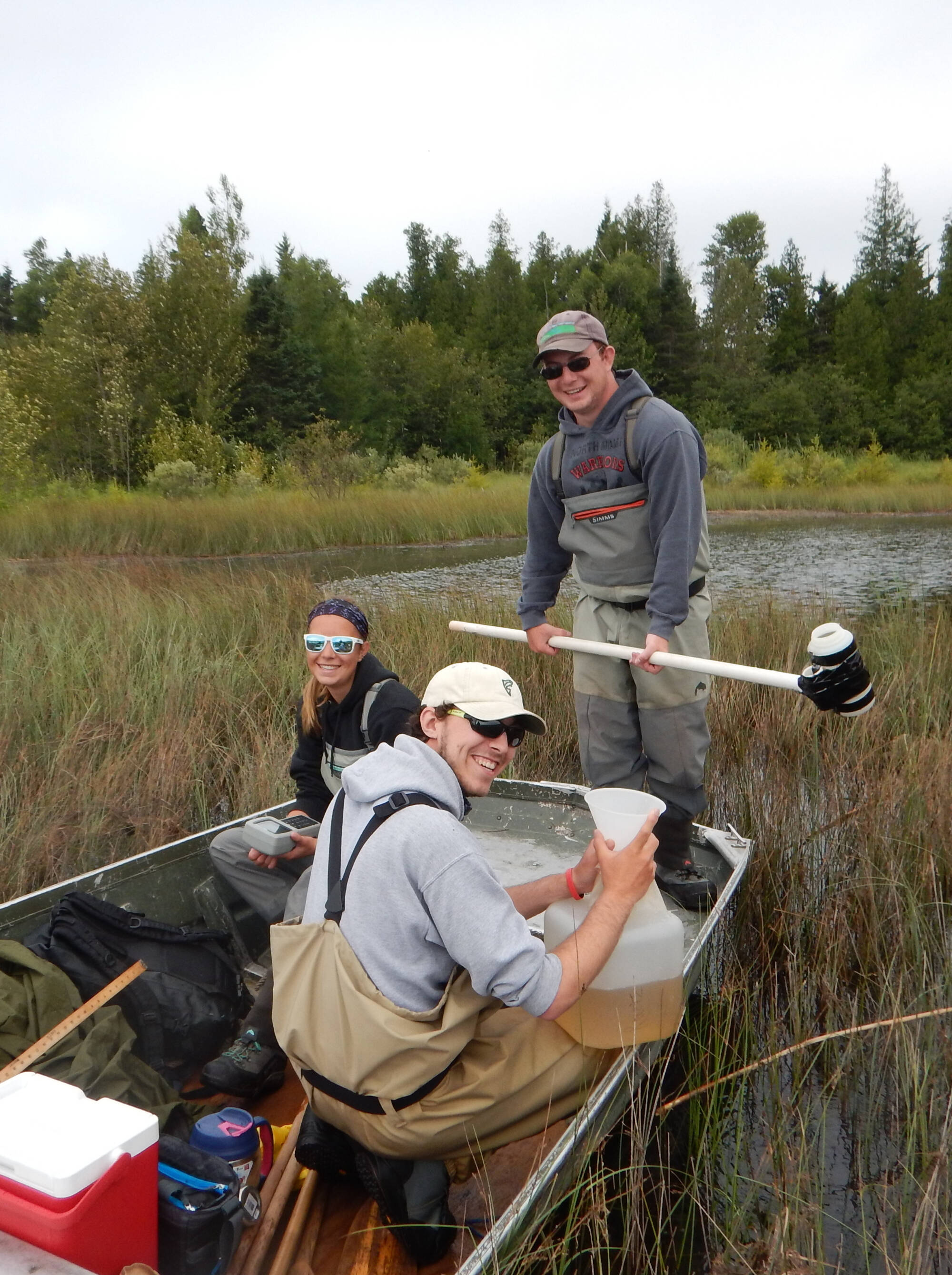 AWRI students pause for a photo while sampling a wetland via jonboat.